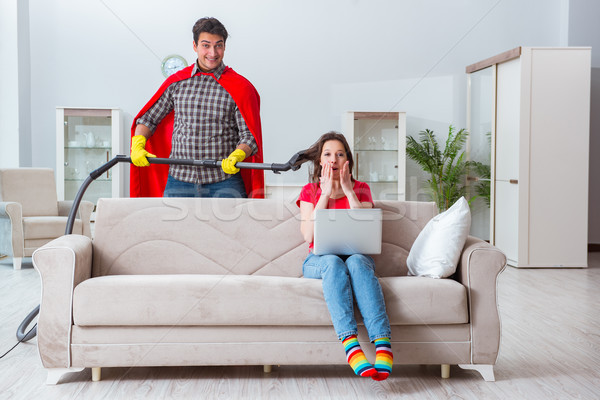 Stock photo: Superhero husband helping his wife at home