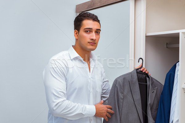 Stock photo: Businessman dressing up for work