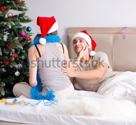 Sexy man in the bed wearing santa hat in christmas concept Stock photo © Elnur