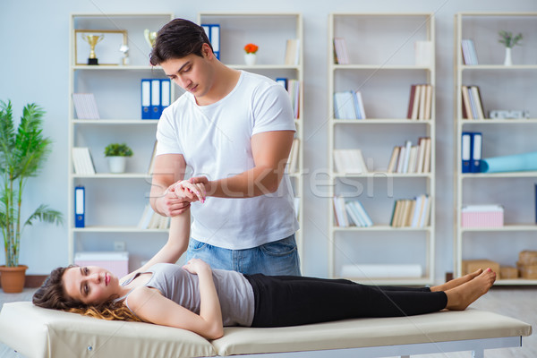 Young doctor chiropractor massaging female patient woman Stock photo © Elnur
