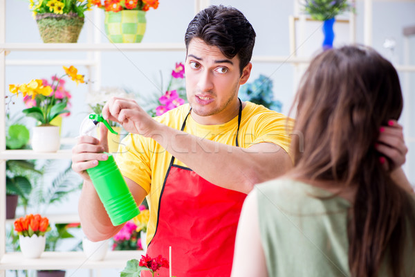 Stock photo: Florist selling flowers in a flower shop