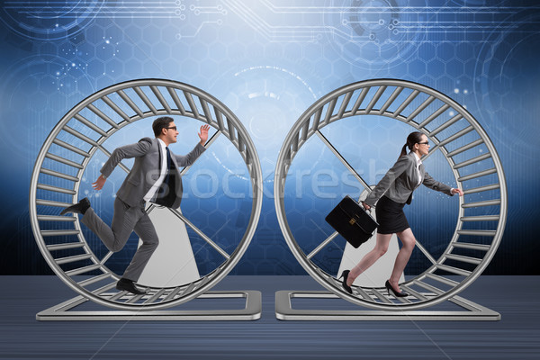 Business concept with pair running on hamster wheel Stock photo © Elnur