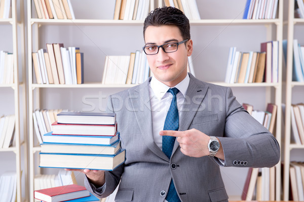 Business law student with pile of books working in library Stock photo © Elnur