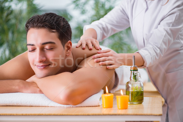 Handsome man during spa massaging session Stock photo © Elnur