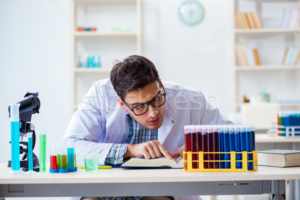 Young chemist student working in lab on chemicals Stock photo © Elnur