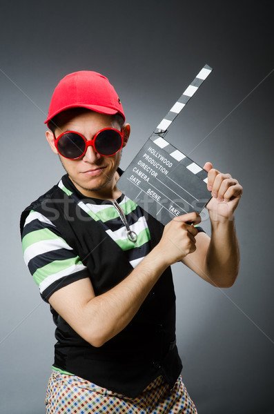 Man with baseball cap and movie board Stock photo © Elnur