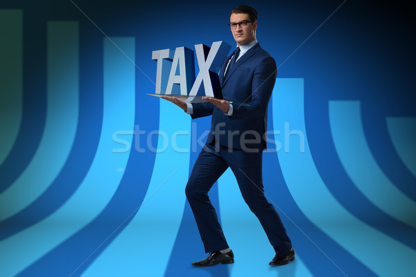 Businessman struggling with high taxes Stock photo © Elnur