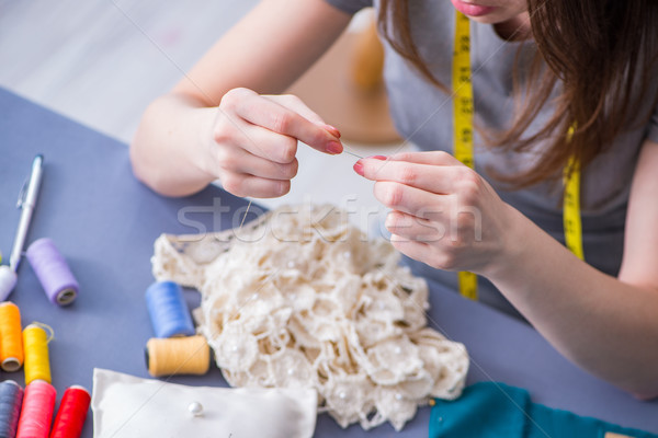 Woman tailor working on a clothing sewing stitching measuring fa Stock photo © Elnur