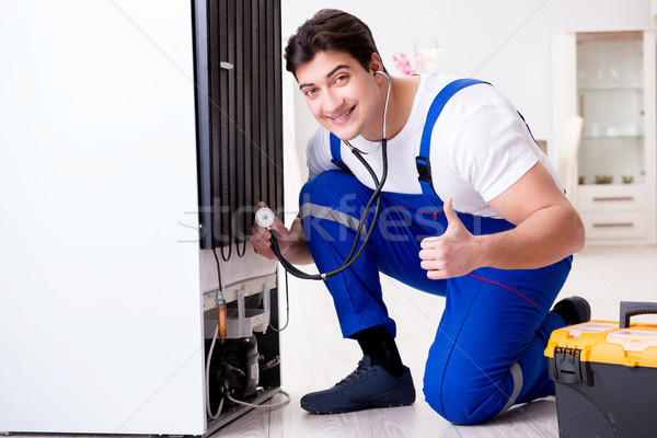 Repairman contractor repairing fridge in DIY concept Stock photo © Elnur