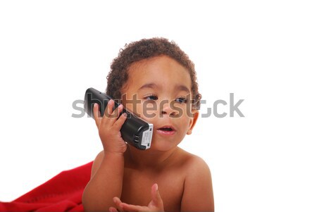 Multi-racial baby wrapped in a blanket playing with a phone Stock photo © elvinstar