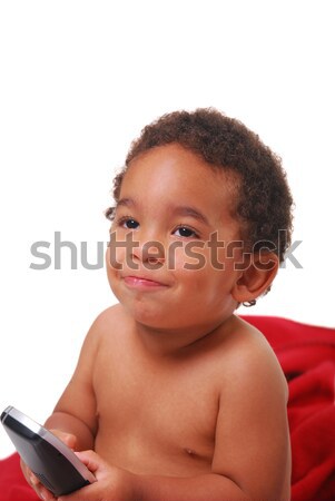 Multi-racial baby wrapped in a blanket playing with a phone Stock photo © elvinstar