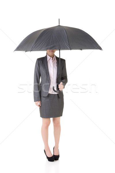 Asian business woman is holding umbrella. Stock photo © elwynn