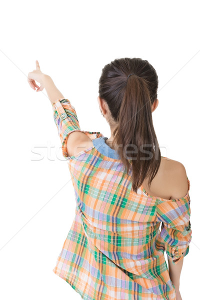 Asian woman points with finger at something Stock photo © elwynn