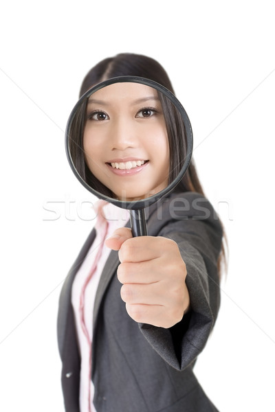 Smiling asian businesswoman holding magnifying glass Stock photo © elwynn