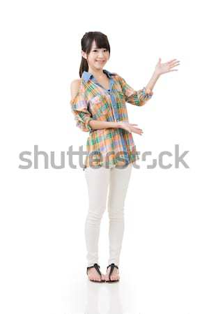Young asian woman shows or introduce something Stock photo © elwynn