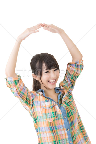 Young asian woman holding both hands above her head Stock photo © elwynn
