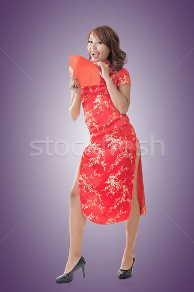Chinese woman dress cheongsam and hold red envelope Stock photo © elwynn