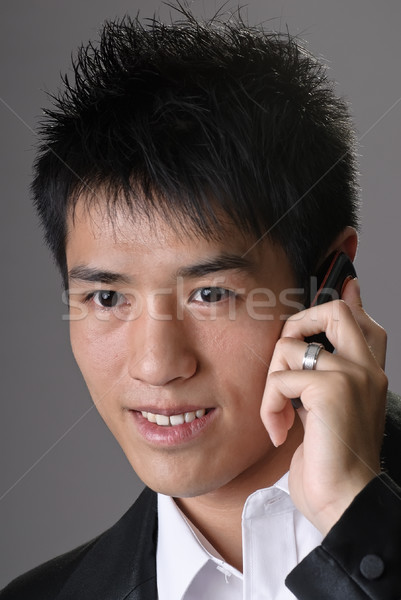 Asia hombre de negocios teléfono celular sonriendo primer plano retrato Foto stock © elwynn