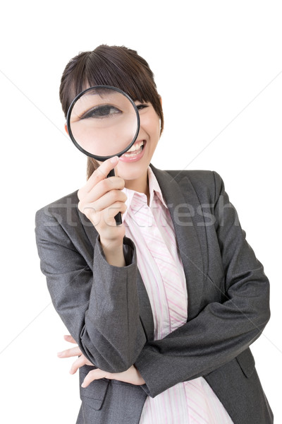 Young asian woman looking through a magnifying glass Stock photo © elwynn