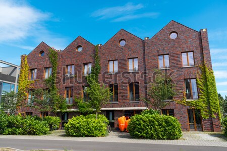 Red brickwall serial houses  Stock photo © elxeneize