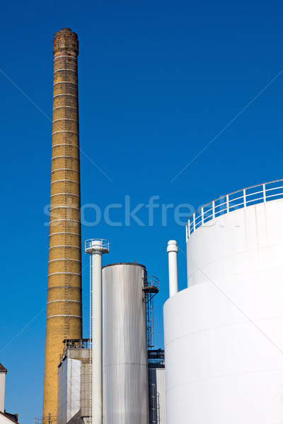Smokestack and industrial tank Stock photo © elxeneize