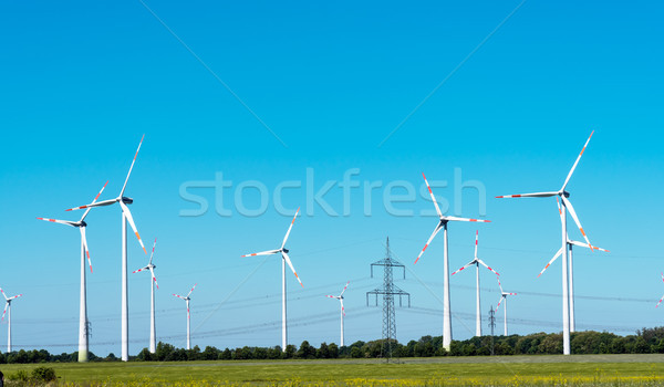 Windwheels and overhead cables in Germany Stock photo © elxeneize