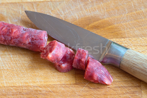 Small salami sliced with a knife Stock photo © elxeneize