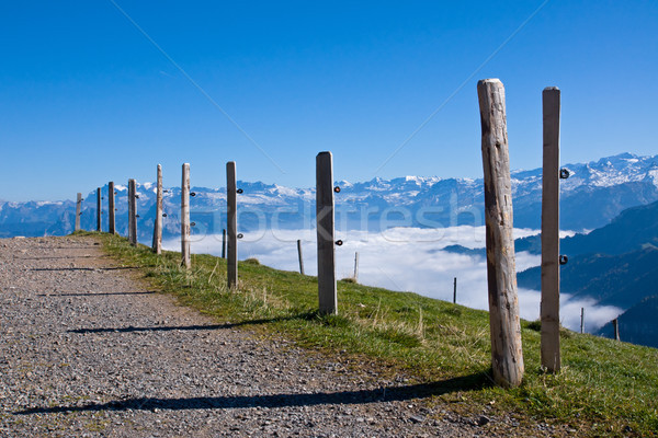 Camino de grava hasta alpes nubes nieve montanas Foto stock © elxeneize