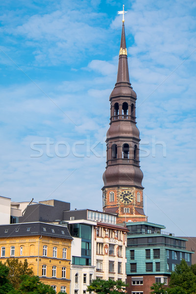 Church and houses in Hamburg Stock photo © elxeneize