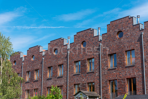 Serial houses with red bricks in Berlin Stock photo © elxeneize