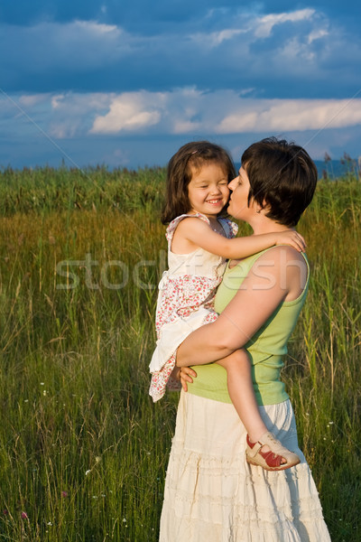Little girl and her mother staying outside Stock photo © emese73