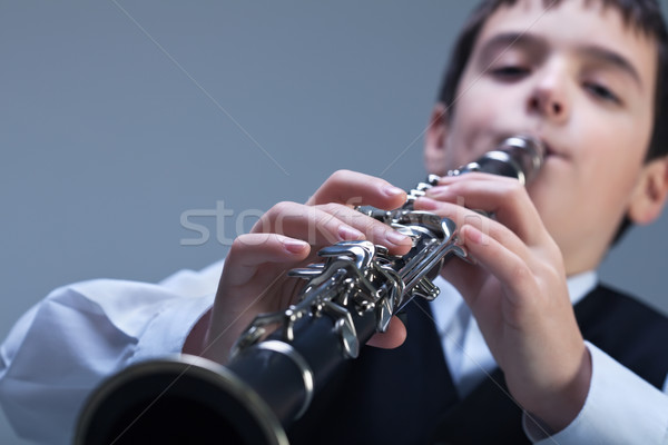 Boy playing on the clarinet Stock photo © emese73