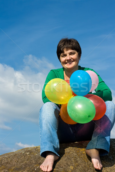 Glücklich Frau Sitzung Stein schöne Frau Ballons Stock foto © emese73