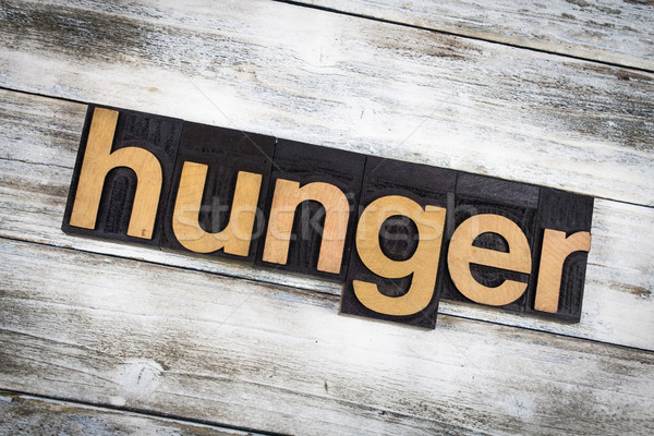 Hunger Letterpress Word on Wooden Background Stock photo © enterlinedesign