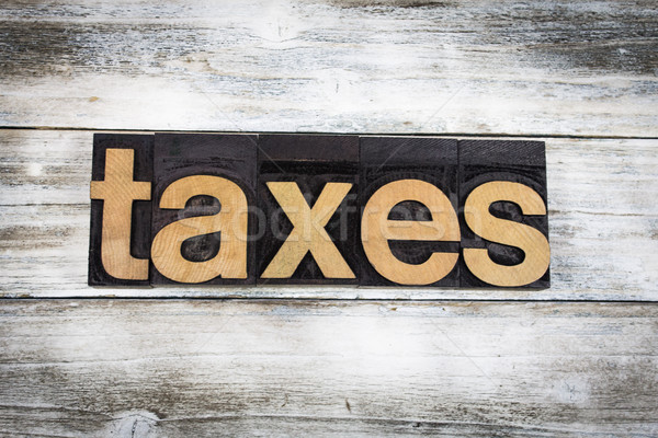 Taxes Letterpress Word on Wooden Background Stock photo © enterlinedesign