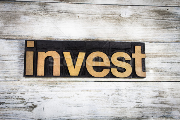 Invest Letterpress Word on Wooden Background Stock photo © enterlinedesign