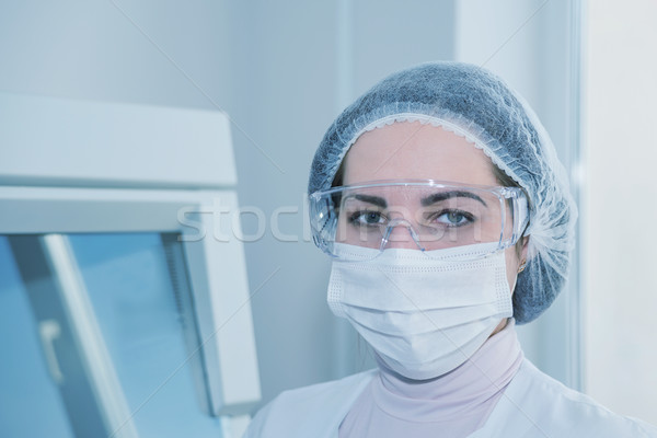 Woman in a white protective clothing Stock photo © Epitavi