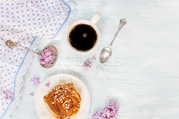 Black coffee and bun with cinnamon Stock photo © Epitavi