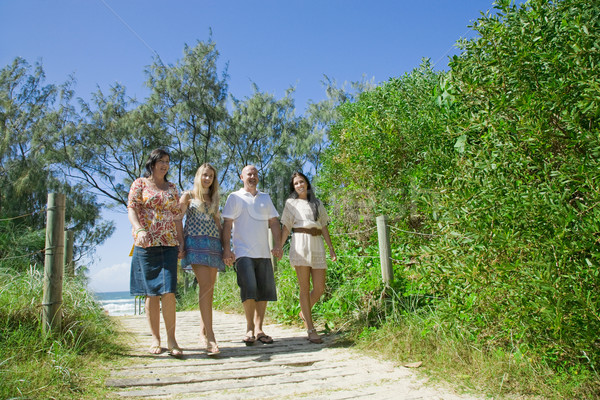 family walking from the beach talking and giggeling Stock photo © epstock