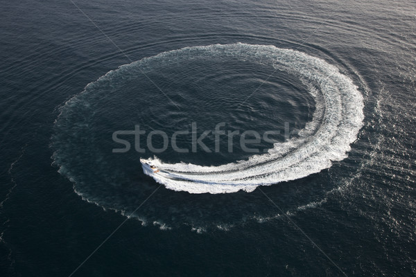 Small yacht making a circle in the water Stock photo © epstock