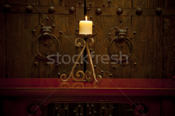 Candles burning on table in front of old rustic door Stock photo © epstock