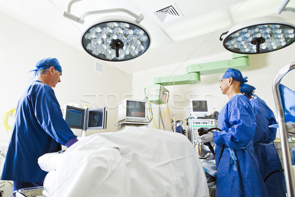 Surgery room with surgeon and nurses Stock photo © epstock