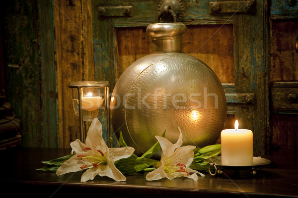 Candles burning on table in front of old rustic door Stock photo © epstock