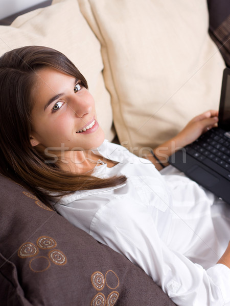Atrakcyjny młoda kobieta za pomocą laptopa kanapie komputera dziewczyna Zdjęcia stock © ErickN