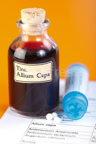 Allium Cepa plant extract, homeopathic pills on sheet Stock photo © erierika