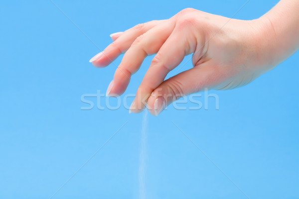 Stock photo: Hand sprinkling salt
