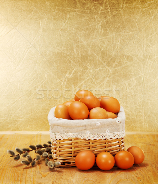 Brown chicken eggs in rustic basket and catkin Stock photo © erierika