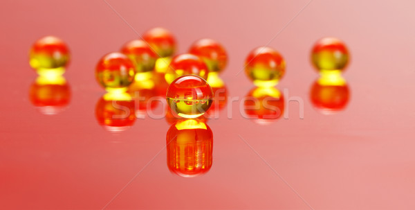 Macro of E vitamine pills on red Stock photo © erierika