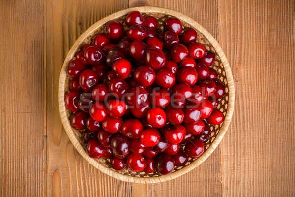 Top view of sweet cherry berries (Prunus avium) in wicker plate Stock photo © erierika
