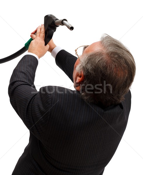 Stock photo: Man looking into gas nozzle
